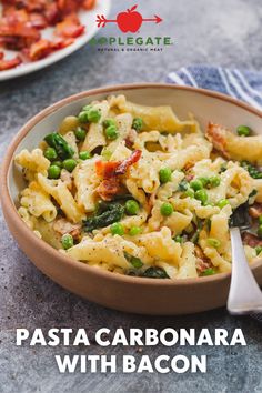 pasta carbonara with bacon and peas in a bowl