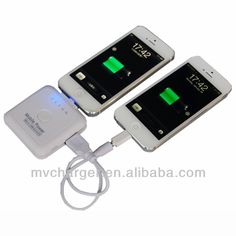 two cell phones are connected to an external charger