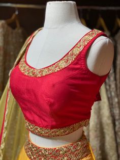 Tuscany yellow plain lehenga with broad gotta patti border teamed with contrasting red blouse and net dupatta. Fabric: Raw Silk This outfit can be customized in multiple colors and specific to client measurements. 90 days of production time is required and are for bulk orders only! Orders are processed in store only! Final fittings/alterations not included. Minimum Order Quantity- 4 pieces Red Sleeveless Lehenga With Zari Work, Fitted Red Lehenga With Gota Work, Red Dola Silk Choli With Gota Work, Fitted Red Choli With Gota Work, Red Blouse Piece With Gota Work, Red Bollywood Choli With Gota Work, Red Bollywood Blouse Piece With Gota Work, Red Unstitched Dola Silk Choli, Red Dola Silk Sets With Unstitched Blouse