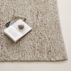 an open book sitting on top of a rug