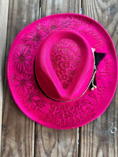 Hand burned Hot Pink, leopard print, floral hat with Bless Your Heart on the brim. This beauty is perfect for your next concert, dinner date or any special occasion. It's simply stunning. Hats are one size fits all with a drawstring to adjust sizing. Spring Party Felt Hat With Flat Brim, Western Style Fedora For Spring Party, Bohemian Fitted Party Hats, Spring Party Western Hat Bands, Western Style Hat Bands For Spring Party, Adjustable Felt Hat For Summer Party, Spring Party Felt Hat With Curved Brim, Summer Leopard Print Hats With Adjustable Fit, Summer Adjustable Leopard Print Hats