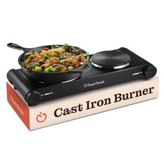 the cast iron burner is sitting on top of a cookbook with food in it