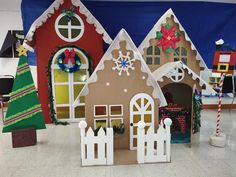 three gingerbread houses decorated with christmas decorations