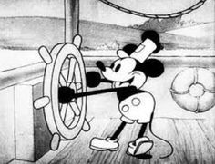 the mickey mouse cartoon is holding on to a wheel