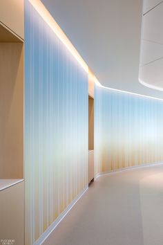 an empty hallway with white walls and blue sky in the backgroung area