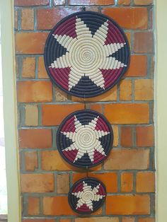 two circular baskets hanging on a brick wall