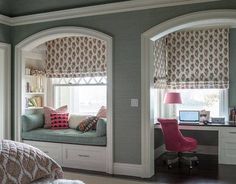 a bedroom with a window seat and desk in the corner, along with built - in bookshelves