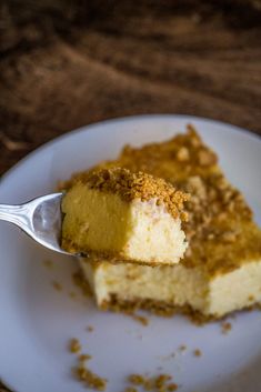 a piece of cake on a white plate with a fork in it and some crumbs