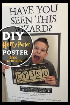 a young boy holding up a harry potter poster