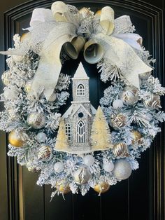 a christmas wreath with bells and ornaments hanging on the front door, decorated with snowflakes