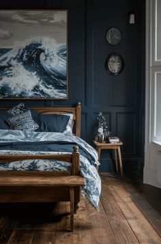 a bed sitting in a bedroom next to a painting on the wall and wooden floors