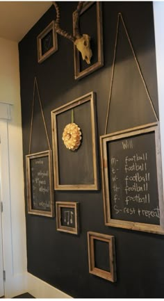 a chalkboard wall with pictures hanging on it