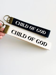 two key chains with the words child of god and child of god printed on them