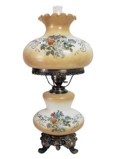 an old fashioned lamp with flowers painted on the glass and metal base is standing upright against a white background