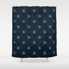 a shower curtain with black and white lines on the fabric, in front of a gray background