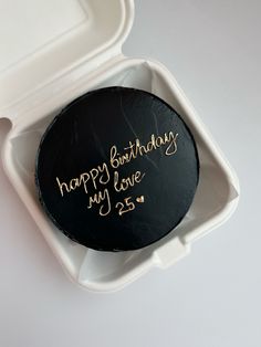 a birthday cake in a box with writing on it