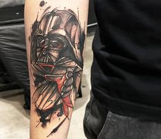 a man with a tattoo on his arm wearing a darth vader mask and holding a knife