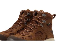 a pair of brown hiking boots with laces