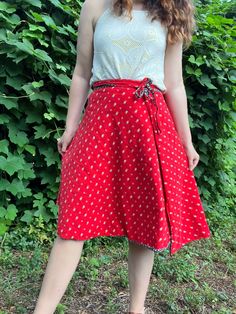 Are you in a blue floral mood or a red floral mood? With this reversible skirt from the 1970s, you can choose the color that suits your whims. It's like having two skirts in one!  This skirt does not have any labels and may have been homemade. It feels like cotton to me. So cute! Fits most similarly to a modern M. Since it's a wrap, it's very flexible and could likely work for a S or L as well. Please review measurements below.  Measurements Waist: 26-32 inches (adjustable) Length: 25.5 inches Condition: Excellent vintage condition. If you have any questions or need additional photos or measurements, please let me know. I'm happy to help! Thank you so much for shopping with Chloris Vintage. --Chandler Red Casual Wrap Skirt For Summer, Retro Red Summer Skirt, Casual Red Wrap Skirt For Summer, Red Lined Flared Wrap Skirt, Red Summer Wrap Skirt With Lining, Retro Red Skirt For Spring, Casual Red Flowy Wrap Skirt, Red Flared Wrap Skirt With Lining, Retro Red Cotton Skirt