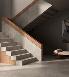 the stairs are made of concrete and have wooden treads on them, along with an upholstered bench