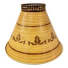 a golden vase with ornate designs on the top and bottom, sitting in front of a white background