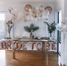 a table with balloons that say bride to be