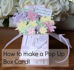 an open box with flowers on it and the words how to make a pop up box card