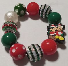 Elastic bracelet with a Christmas color themed. All bracelets are adult size unless otherwise specified. Cute Adjustable Christmas Jewelry, Themed Green Beaded Bracelets For Gifts, Adjustable Green Christmas Bracelets, Themed Green Beaded Bracelets As Gift, Green Themed Beaded Bracelets As Gifts, Adjustable Green Bracelets For Christmas, Green Christmas Bracelet, Adjustable Green Bracelets For Holiday, Mickey Minnie Christmas