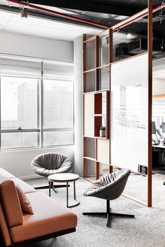 an office with two chairs and a couch