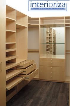 an empty walk in closet with drawers and shelves