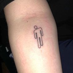 a small tattoo on the arm of a person with a stick man symbol in it