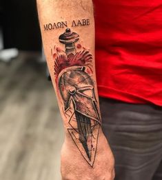 a man with a tattoo on his arm that says molonn aabe and an arrow