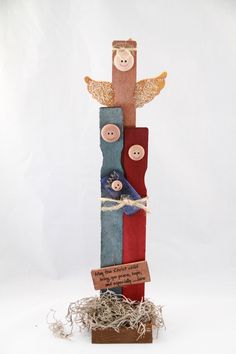 a wooden sculpture with buttons and words on it