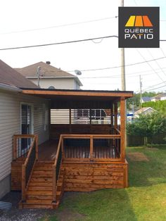 a wooden deck with steps leading up to the roof and side of a house that has a patio attached to it