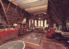 an old fashioned living room with lots of furniture and rugs on the wooden floor