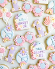 decorated cookies are arranged in the shape of numbers and nameplates for children's first birthday