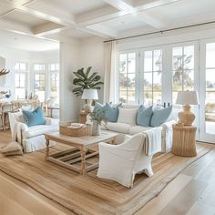 a living room filled with furniture and lots of windows