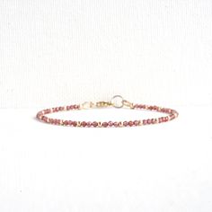 Red Garnet Dainty Bracelet Finished with a lobster claw clasp. *BRACELET LENGTH- 6.5 - 8.0 Inches* * MATERIALS & DIMENSIONS *  * Red Garnet Beads: about 2.0 mm - Grade AAA  * Gold Filled or Sterling Silver Beads: about 2.0 mm * Silver or Gold Filled Findings * Premium Strong Flexible Beading Wire *Arrives in a gift box* Choose Your Bracelet Length Use a tape measure. Wrap the tape measure around the wrist on which you plan to wear your bracelet. Make a note of the number at the point where the t Adjustable Burgundy Bracelets, Adjustable Burgundy Bracelet, Adjustable Burgundy Round Bead Bracelets, Adjustable Red Jewelry With Lobster Clasp, Black Onyx Bracelet, Garnet Bracelet, Clasp Bracelet, Dainty Bracelet, Onyx Bracelet