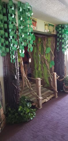 a room decorated in green and purple for st patrick's day with paper decorations