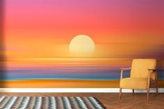 a chair sitting on top of a wooden floor in front of a sunset wall mural