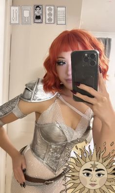 a woman with red hair is taking a selfie