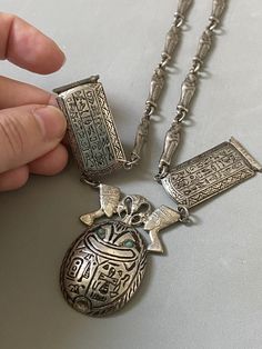 Very rare, the 1940s giant Egyptian Scarab necklace from silver 800,  hallmarked with Egyptian hallmarks for 1946,  and silver 800. Hollow silver (empty) necklace with oversized figures of the  Scarab with turquoise stone eyes,  with lotus flower and  Nefertitis on the top, with  Hieroglyphs tables and actually -  everywhere, and with mummies as a chain. The  necklace is short, close to the neckline, 39.5cm long. If you need longer, you could buy an extension chain from internet.   Condition is Scarab Necklace, Egyptian Scarab, Turquoise Stone, Lotus Flower, Very Rare, Uk Shop, Favorite Jewelry, Vintage Shops, Jewelry Necklace Pendant