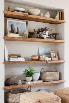 the shelves are filled with baskets and pictures