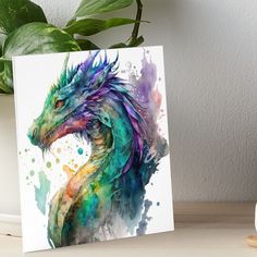 a watercolor painting of a dragon on a white background art boarder next to a potted plant