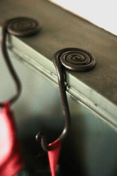 an umbrella is hanging on the side of a wall near a coat rack with hooks