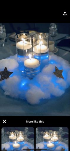 some candles that are sitting in the clouds with stars on them, and one is lit up