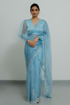 Powder blue silk organza saree with zardosi hand embroidered borders. Comes with a blouse.
Components: 2
Pattern: Hand embroidered
Type Of Work: Zardosi
Neckline: V Neck
Sleeve Type: Puffed Sleeves
Fabric: Silk organza
Color: Blue
Other Details: 
Disclaimer : The product will dispose off some color, since it is hand dyed.
Occasion: Wedding - Aza Fashions Luxury Blue Saree With Unstitched Blouse, Luxury Organza Pre-draped Saree With Dori Work, Luxury Dori Work Saree, Ceremonial Saree With Dori Work, Luxury Organza Blouse Piece With Dori Work, Luxury Blue Pre-draped Saree With Dori Work, Luxury Blue Organza Saree, Luxury Saree With Dori Work For Festive Occasions, Cheap Dori Work Saree For Puja