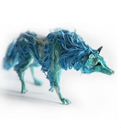 an animal made out of blue yarn on a white background