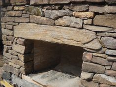 a stone fireplace built into the side of a building with no fire place in it