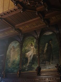 three paintings on the wall in a building